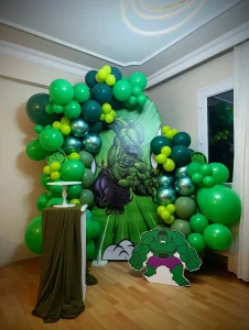 Green and white balloon garland backdrop for a birthday party