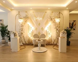 Modern engagement stage with white backdrop and armchairs