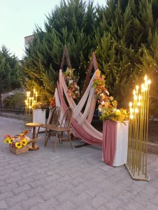 Outdoor engagement corner with pink drapes, sunflowers and candles