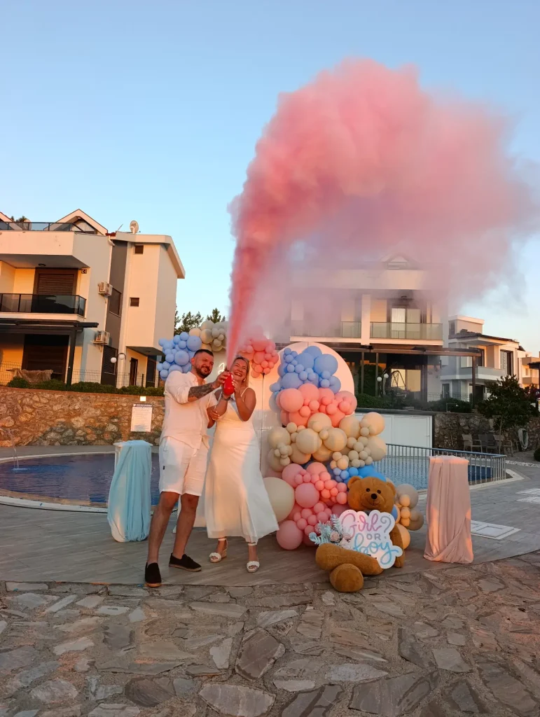 Pink smoke and balloon decoration at a celebration in Kusadasi