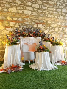 Celebration table with white draped fabric and balloon decoration