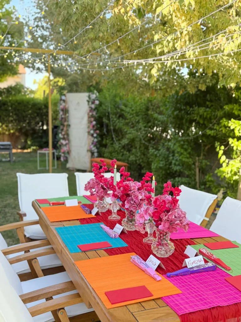 Pink dessert table with balloons and flowers for a hen party