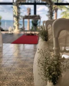 Indoor wedding ceremony with red carpet and sea view in Kusadasi