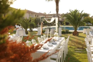 Garden wedding setup with white chairs by the pool in Kusadasi