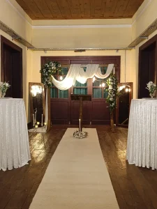Indoor wedding ceremony hall with white drapes and aisle in Kusadasi