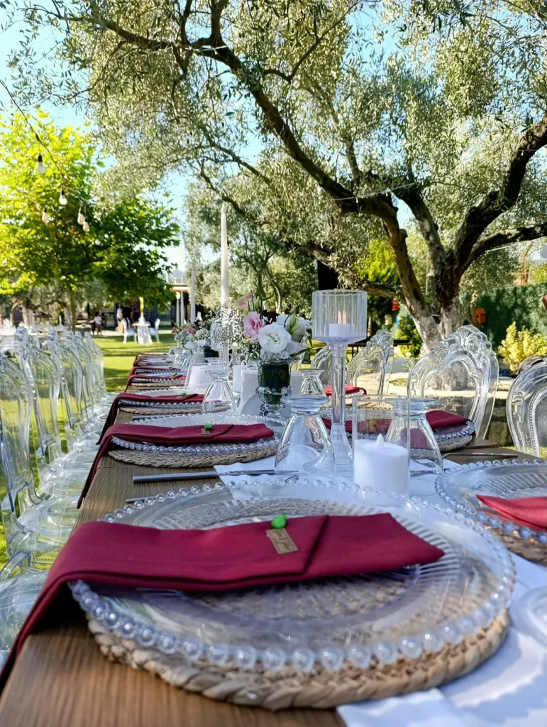 Outdoor wedding dinner table under olive trees in Kusadasi
