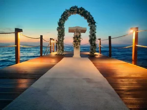 Floral wedding arch on a wooden pier by the sea in Kusadasi