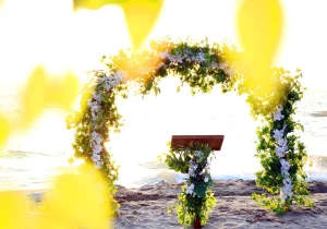 Beach wedding Turkey floral arch with wooden lectern on the sand