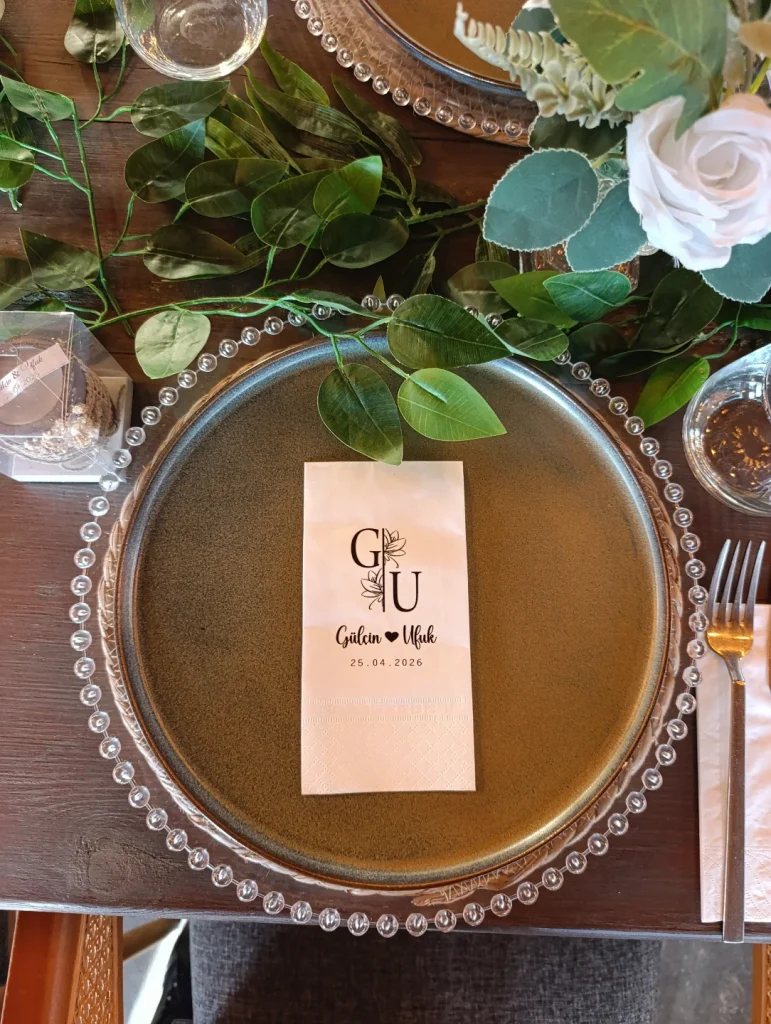 Wedding table setting with monogram place card, glass charger plate and white rose in Kusadasi