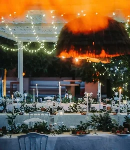 Evening wedding dinner with string lights and candles in Kusadasi