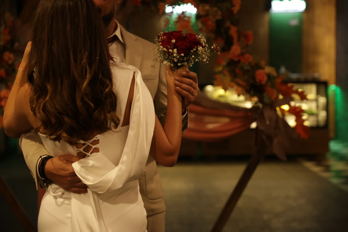 Bride and groom embracing at an evening wedding in Kusadasi