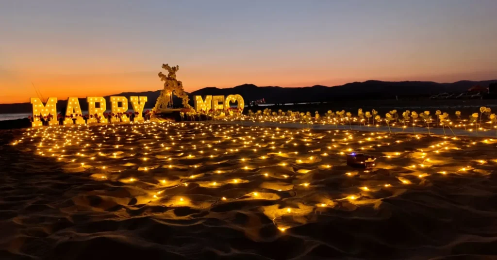 Marry Me letters on the sand at sunset in Kusadasi