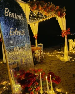 Floral arch with warm string lights for a surprise proposal